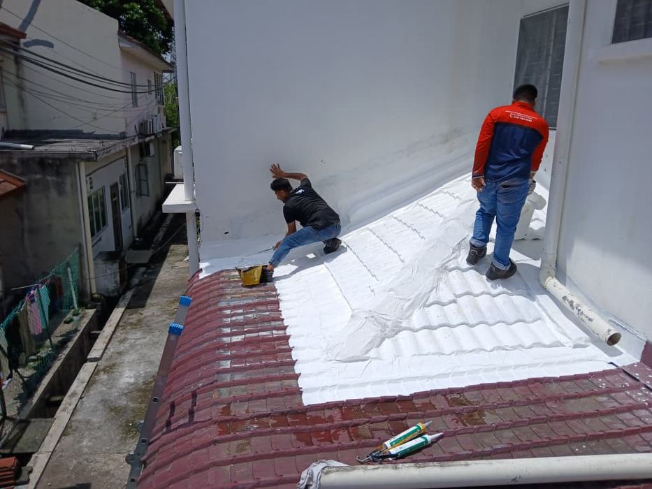 Victra crew waterproofing a rooftop over roof tiles on a real project in Malaysia