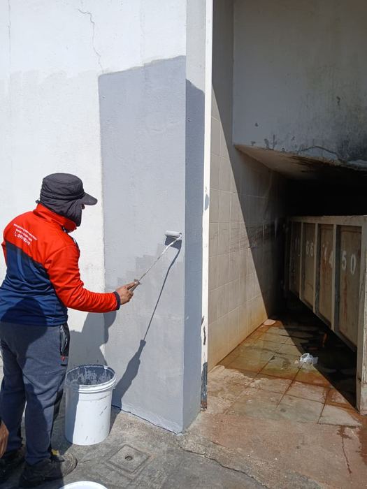 Victra technician on a bathroom wall leak repair